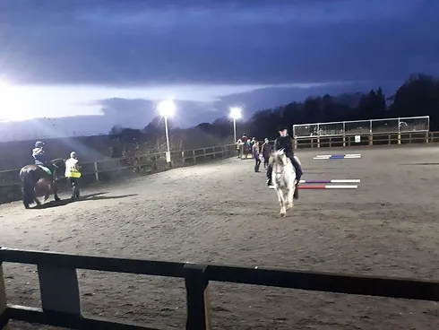 Riders riding in the dark with lights on